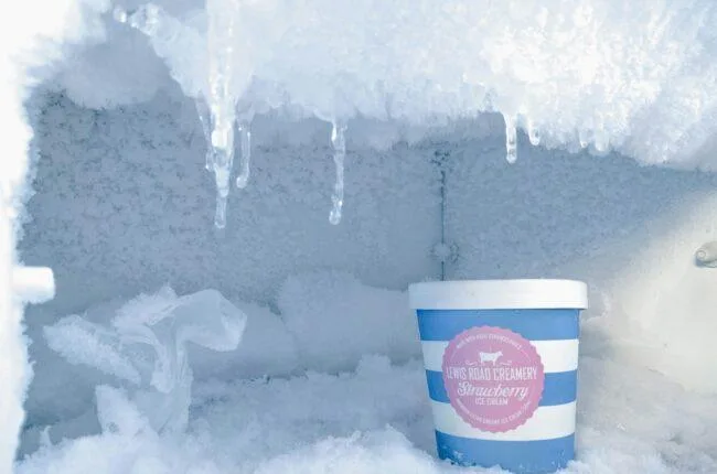 strawberry ice cream bottle inside container covered in ice